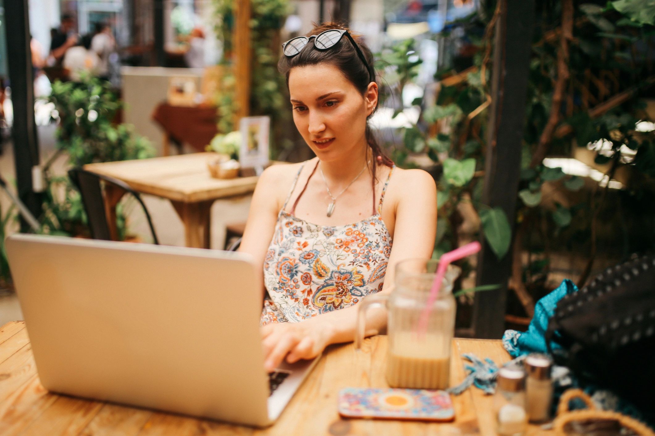 Portrait of a freelancer working on a laptop in a cafe
