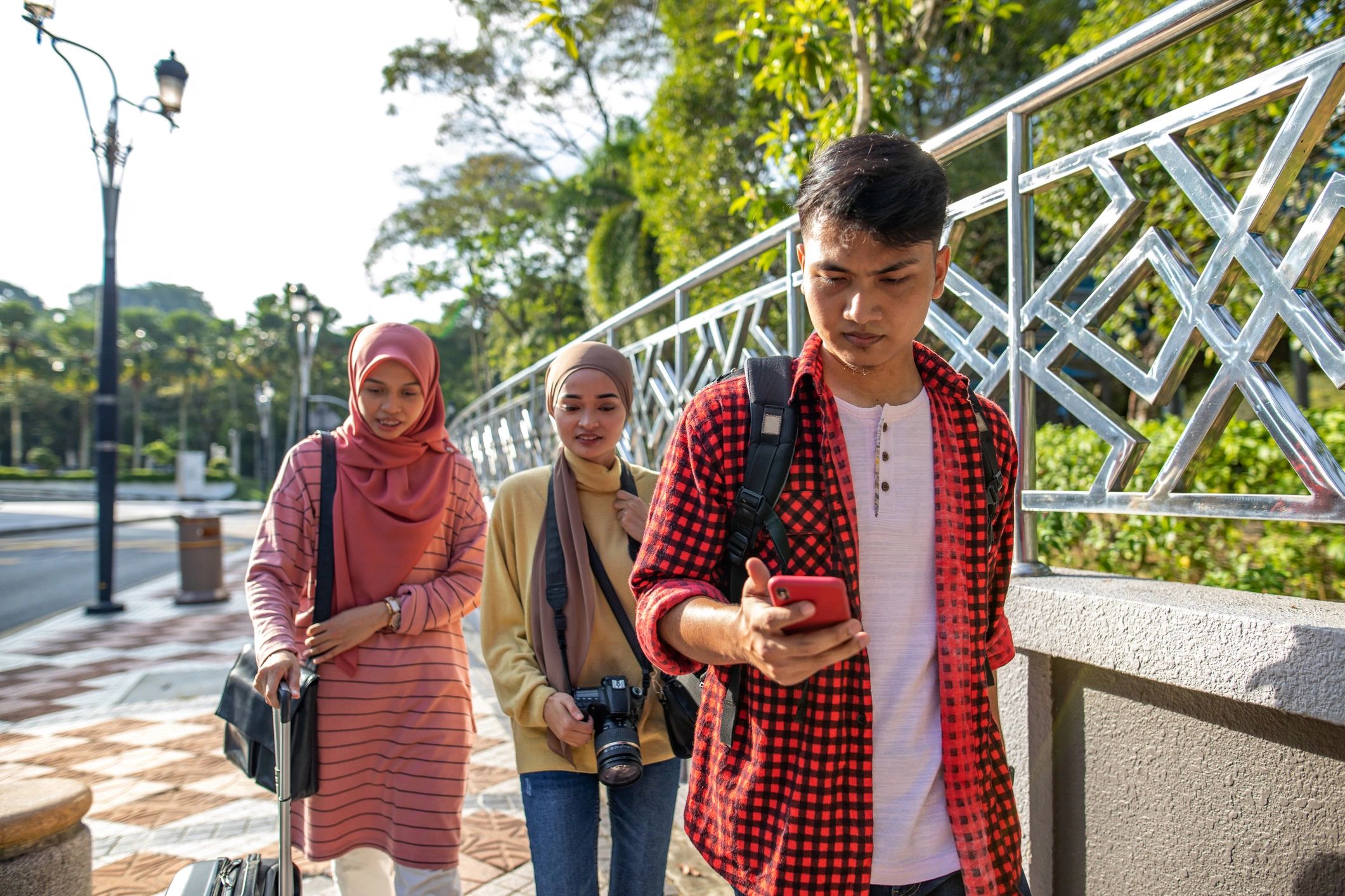 Friends checking a smartphone map while traveling