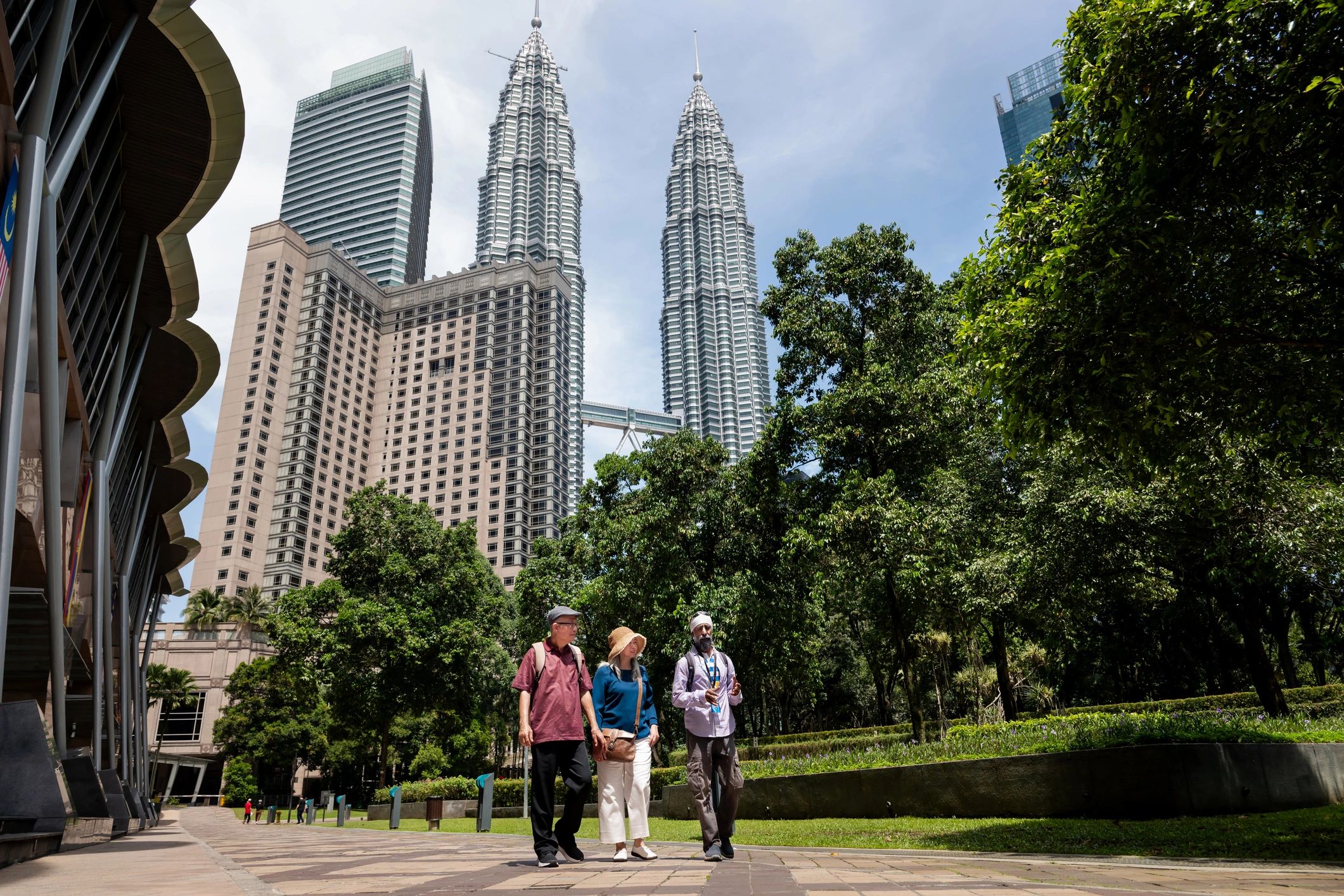 Travelers visiting the Petronas Twin Towers in Kuala Lumpur