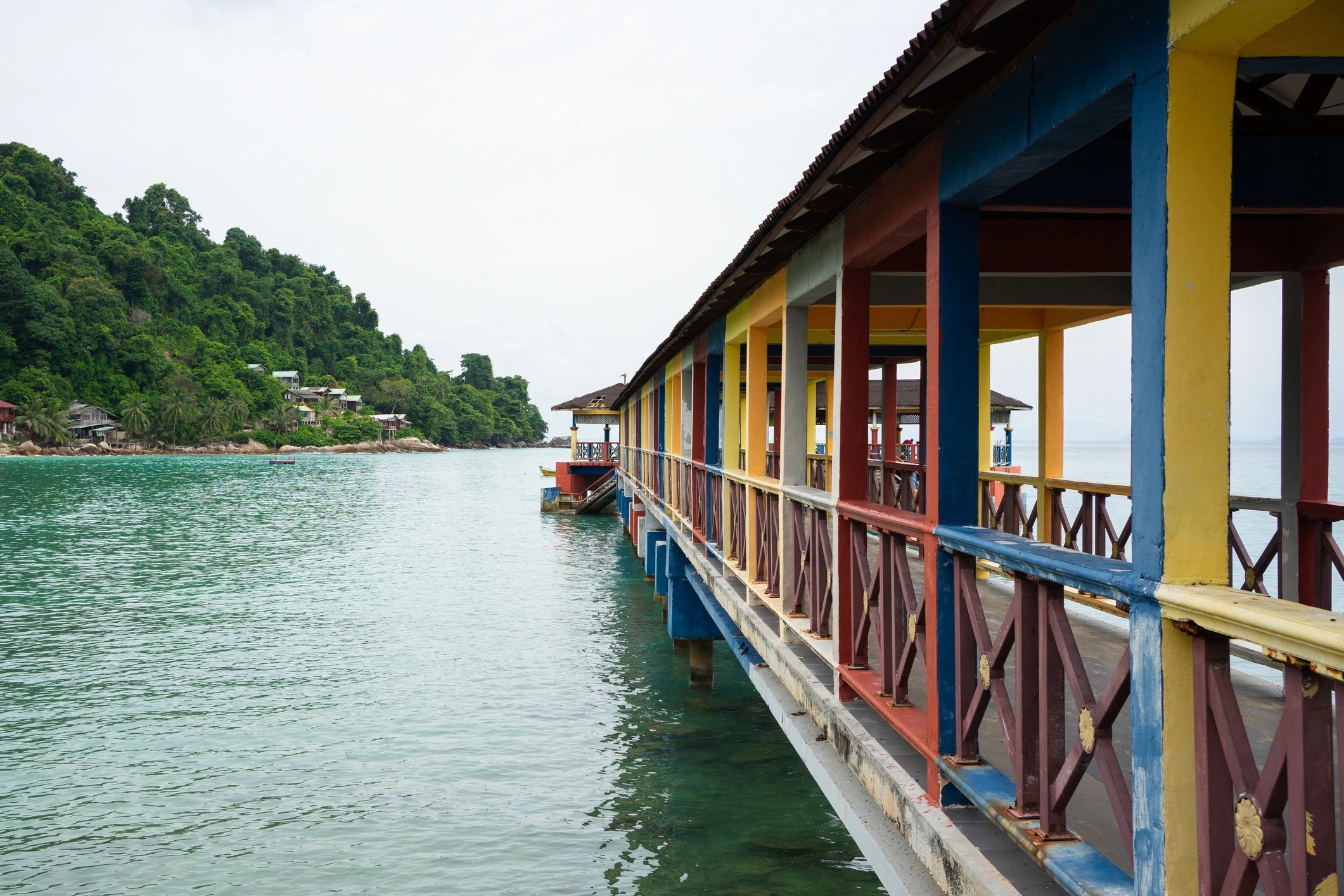 Island coastline and pier with turquoise water